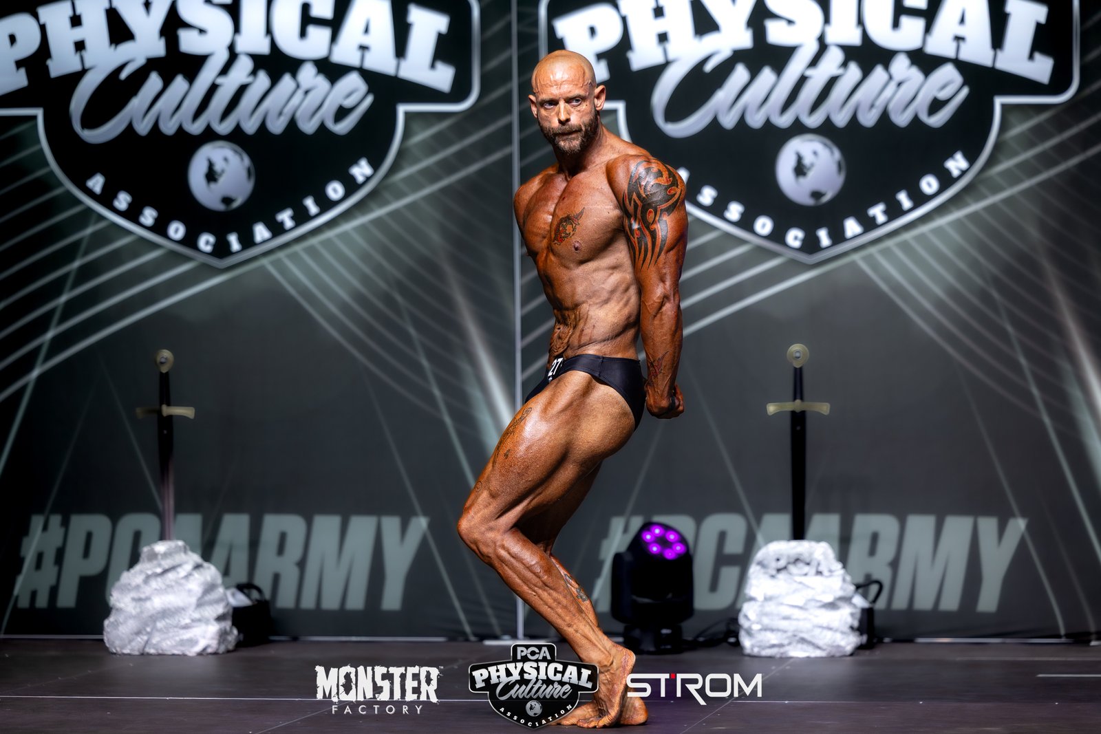 Coach Phil on a bodybuilding stage - CS Fitness